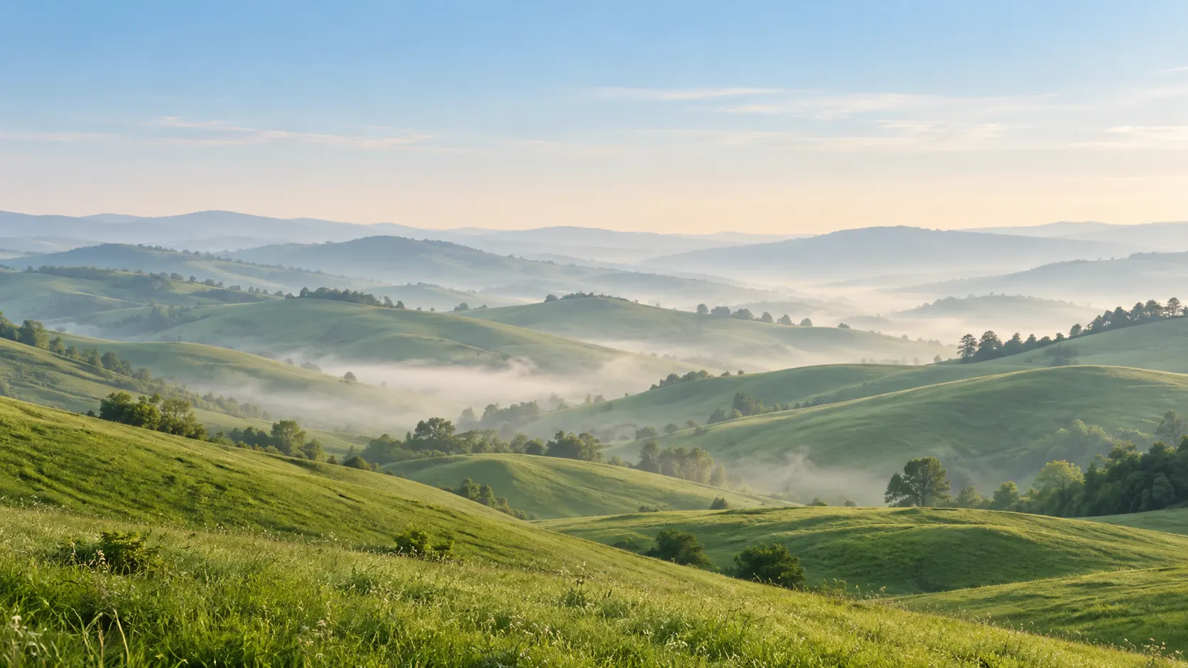 Layers of green hills with mist in the valleys